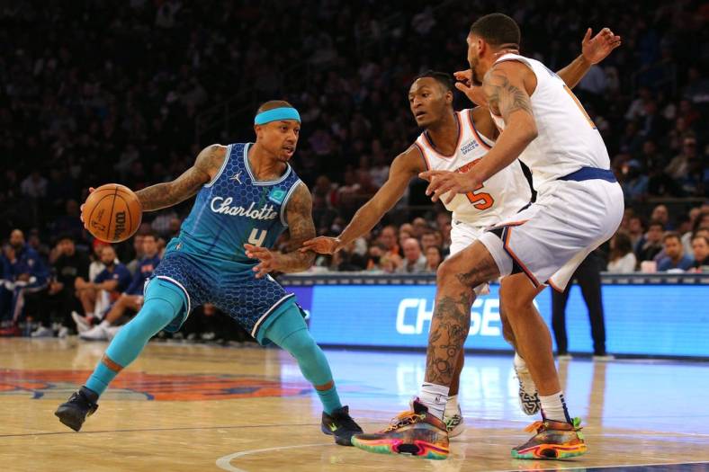 Mar 30, 2022; New York, New York, USA; Charlotte Hornets guard Isaiah Thomas (4) controls the ball against New York Knicks guard Immanuel Quickley (5) and forward Obi Toppin (1) during the second quarter at Madison Square Garden. Mandatory Credit: Brad Penner-USA TODAY Sports