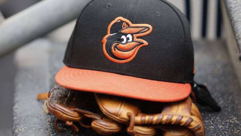 May 14, 2022; Detroit, Michigan, USA;  Baltimore Orioles cap and glove sits in dugout in the second inning against the Detroit Tigers at Comerica Park. Mandatory Credit: Rick Osentoski-USA TODAY Sports