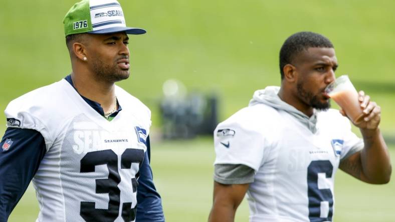 Jun 7, 2022; Renton, Washington, USA; Seattle Seahawks strong safety Jamal Adams (33) and free safety Quandre Diggs (6) walk on the field during minicamp practice at the Virginia Mason Athletic Center Field. Mandatory Credit: Joe Nicholson-USA TODAY Sports