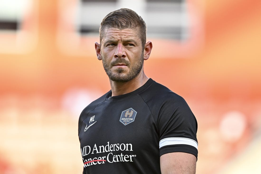 Jun 12, 2022; Houston, Texas, USA; Houston Dash goalkeeper coach Matt Lampson enters the pitch prior to the start of the second half against the Portland Thorns FC in a NWSL match at PNC Stadium. Mandatory Credit: Maria Lysaker-USA TODAY Sports