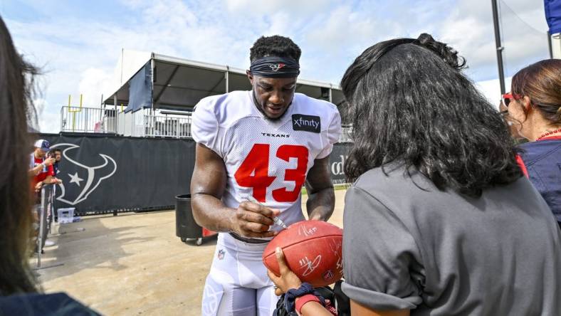 Aug 5, 2022; Houston, Texas, US; Houston Texans linebacker Neville Hewitt (43) signs autographs after training camp at the Texans practice facility.  Mandatory Credit: Maria Lysaker-USA TODAY Sports