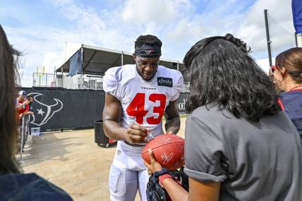Aug 5, 2022; Houston, Texas, US; Houston Texans linebacker Neville Hewitt (43) signs autographs after training camp at the Texans practice facility.  Mandatory Credit: Maria Lysaker-USA TODAY Sports