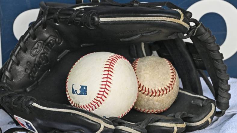 Aug 14, 2022; Kansas City, Missouri, USA;  A general view of a baseball glove and baseballs prior to a game between the Kansas City Royals and Los Angeles Dodgers at Kauffman Stadium. Mandatory Credit: Peter Aiken-USA TODAY Sports