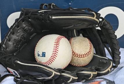 Aug 14, 2022; Kansas City, Missouri, USA;  A general view of a baseball glove and baseballs prior to a game between the Kansas City Royals and Los Angeles Dodgers at Kauffman Stadium. Mandatory Credit: Peter Aiken-USA TODAY Sports