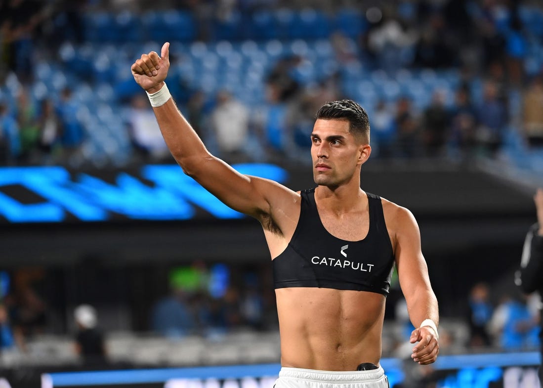 Oct 5, 2022; Charlotte, North Carolina, USA; Charlotte FC forward Daniel Rios (12) signals to the fans after the game at Bank of America Stadium. Mandatory Credit: Bob Donnan-USA TODAY Sports