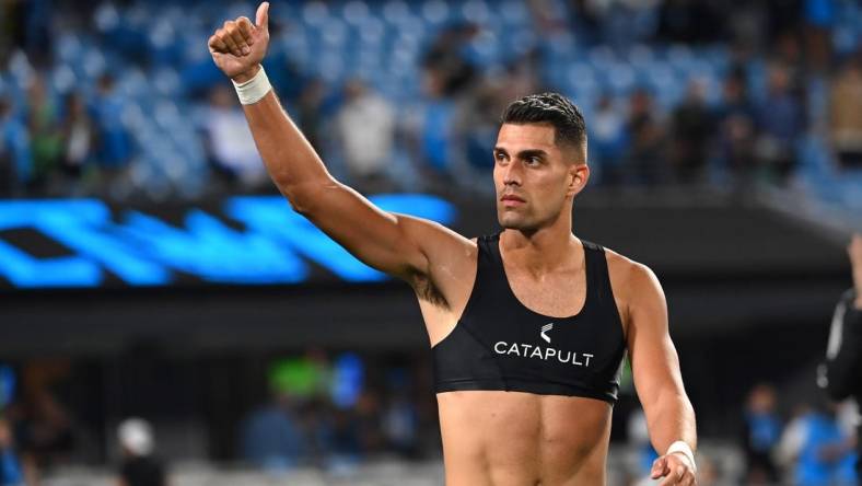 Oct 5, 2022; Charlotte, North Carolina, USA; Charlotte FC forward Daniel Rios (12) signals to the fans after the game at Bank of America Stadium. Mandatory Credit: Bob Donnan-USA TODAY Sports