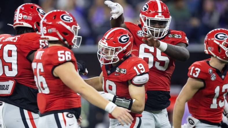 Georgia Bulldogs tight end Brock Bowers (19) celebrates a touchdown with offensive lineman Amarius Mims (65) against the TCU Horned Frogs during the CFP national championship game at SoFi Stadium. Mandatory Credit: Mark J. Rebilas-USA TODAY Sports