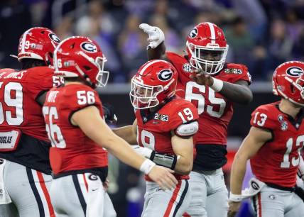 Georgia Bulldogs tight end Brock Bowers (19) celebrates a touchdown with offensive lineman Amarius Mims (65) against the TCU Horned Frogs during the CFP national championship game at SoFi Stadium. Mandatory Credit: Mark J. Rebilas-USA TODAY Sports