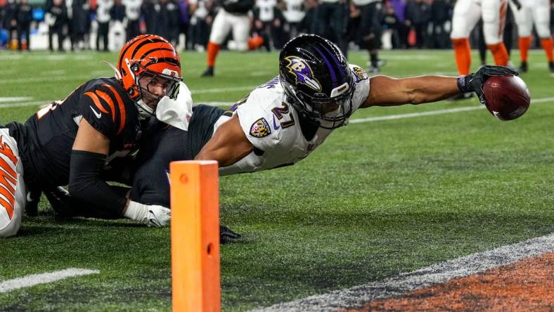 Baltimore Ravens running back J.K. Dobbins (27) breaks a tackle from Cincinnati Bengals linebacker Markus Bailey (51) stretches to break the plane for a touchdown in the second quarter during an NFL wild-card playoff football game between the Baltimore Ravens and the Cincinnati Bengals, Sunday, Jan. 15, 2023, at Paycor Stadium in Cincinnati.The Ravens led 10-9 at halftime.

Baltimore Ravens At Cincinnati Bengals Afc Wild Card Jan 15 124