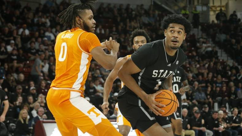 Jan 17, 2023; Starkville, Mississippi, USA; Mississippi State Bulldogs forward Tolu Smith (1) spins toward the basket as Tennessee Volunteers forward Jonas Aidoo (0) defends during the second half at Humphrey Coliseum. Mandatory Credit: Petre Thomas-USA TODAY Sports