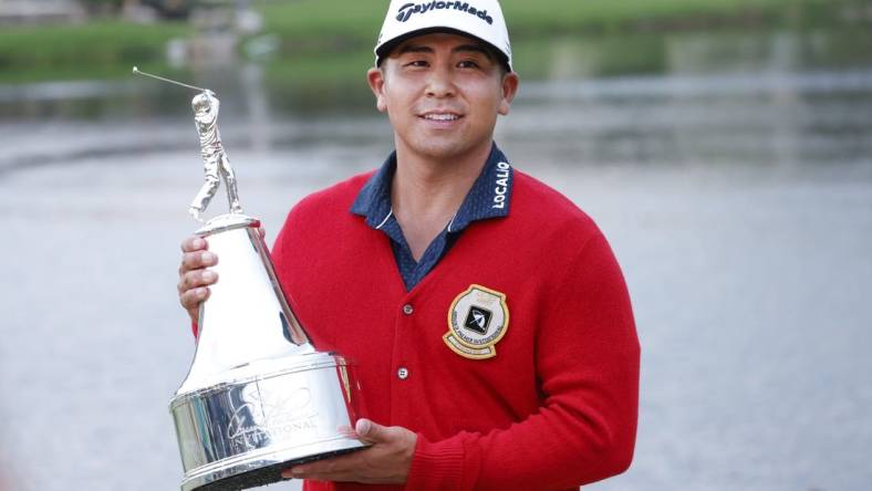 Mar 5, 2023; Orlando, Florida, USA;  Kurt Kitayama holds the champions trophy after winning the Arnold Palmer Invitational golf tournament. Mandatory Credit: Reinhold Matay-USA TODAY Sports