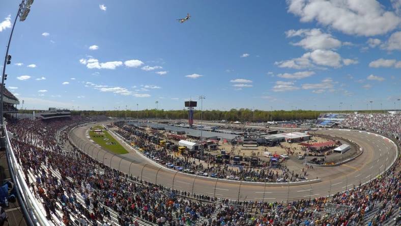 Apr 2, 2023; Richmond, Virginia, USA; A US Coast Guard C-130 performs a flyby before the start of the Toyota Owners 400 in this overall view of Richmond Raceway. Mandatory Credit: John David Mercer-USA TODAY Sports