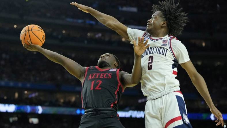 Apr 3, 2023; Houston, TX, USA; San Diego State Aztecs guard Darrion Trammell (12) shoots the ball against Connecticut Huskies guard Tristen Newton (2) during the second half in the national championship game of the 2023 NCAA Tournament at NRG Stadium. Mandatory Credit: Bob Donnan-USA TODAY Sports