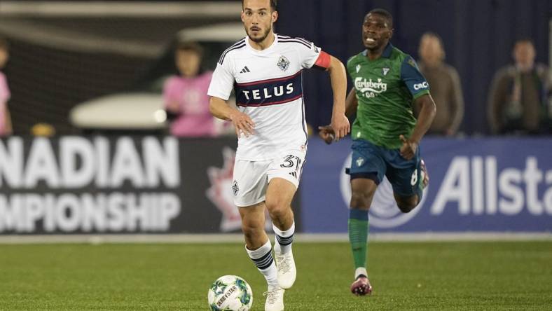 May 10, 2023; Toronto, Ontario, CAN; Vancouver Whitecaps midfielder Russell Teibert (31) dribbles the ball downfield against York United  during the second half at York Lions Stadium. Mandatory Credit: John E. Sokolowski-USA TODAY Sports