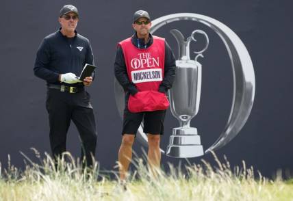 July 21, 2023; Hoylake, ENGLAND, GBR; Phil Mickelson (LIV player) and his caddie Tim Mickelson on the first hole during the second round of The Open Championship golf tournament at Royal Liverpool. Mandatory Credit: Kyle Terada-USA TODAY Sports