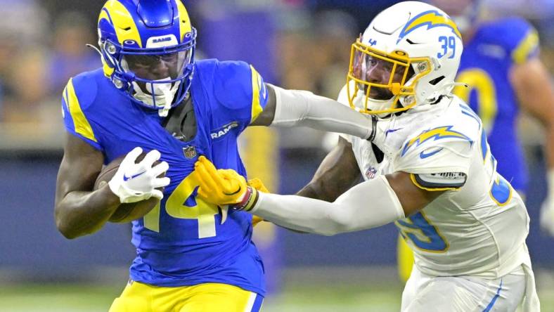 Aug 12, 2023; Inglewood, California, USA;   Los Angeles Rams wide receiver Tyler Johnson (14) is stopped by Los Angeles Chargers cornerback Michael Jacquet (39) after a first down in the second half at SoFi Stadium. Mandatory Credit: Jayne Kamin-Oncea-USA TODAY Sports