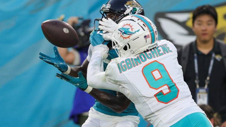 Aug 26, 2023; Jacksonville, Florida, USA;  Jacksonville Jaguars wide receiver Calvin Ridley (0) makes a catch defended by Miami Dolphins cornerback Noah Igbinoghene (9) in the second quarter at EverBank Stadium. Mandatory Credit: Nathan Ray Seebeck-USA TODAY Sports