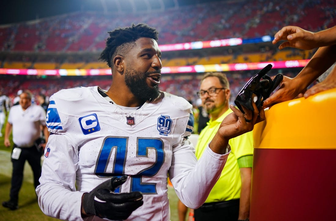 Sep 7, 2023; Kansas City, Missouri, USA; Detroit Lions linebacker Jalen Reeves-Maybin (42) gives a glove to a fan after defeating the Kansas City Chiefs at GEHA Field at Arrowhead Stadium. Mandatory Credit: Jay Biggerstaff-USA TODAY Sports