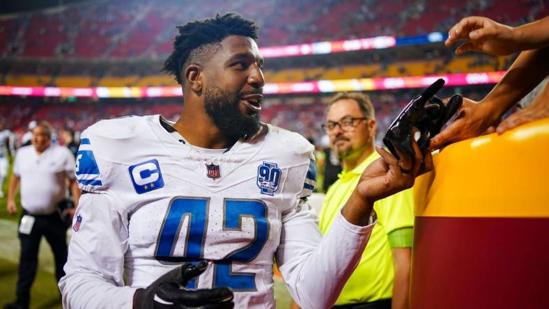 Sep 7, 2023; Kansas City, Missouri, USA; Detroit Lions linebacker Jalen Reeves-Maybin (42) gives a glove to a fan after defeating the Kansas City Chiefs at GEHA Field at Arrowhead Stadium. Mandatory Credit: Jay Biggerstaff-USA TODAY Sports