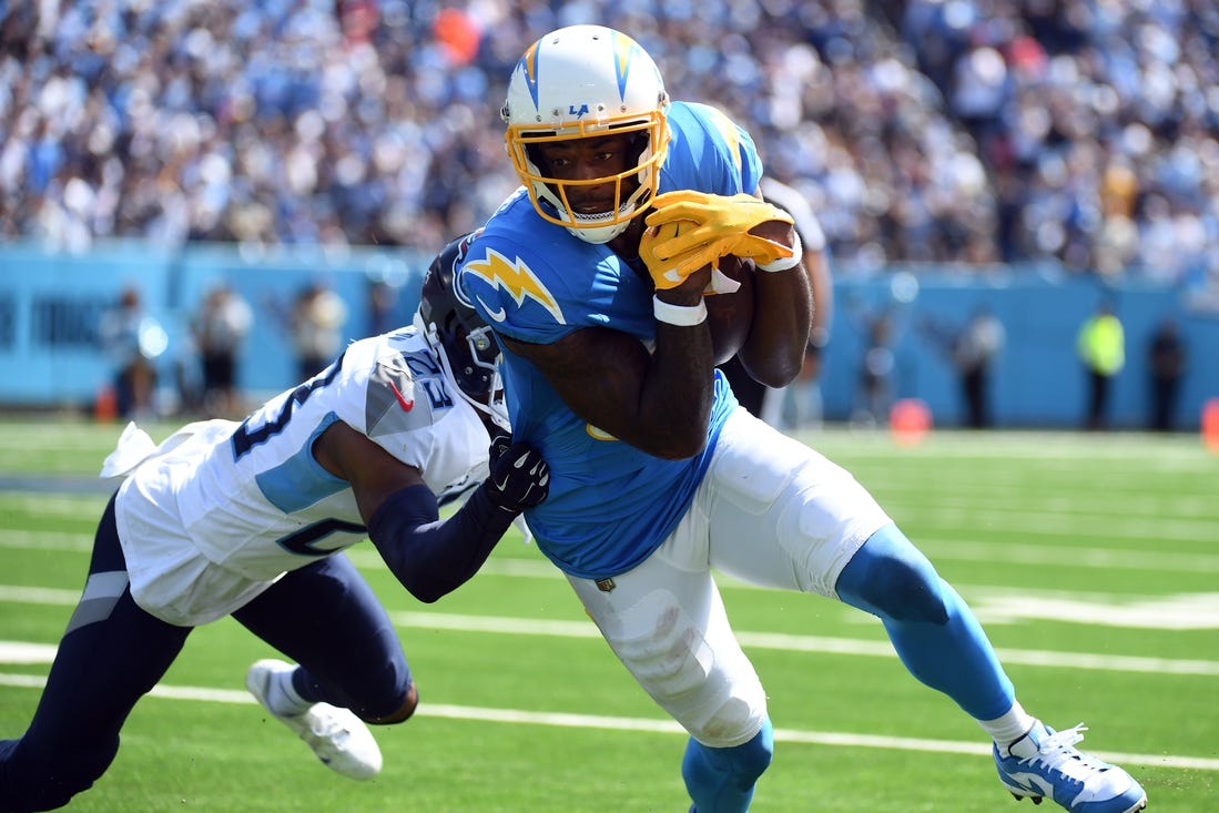 Sep 17, 2023; Nashville, Tennessee, USA; Los Angeles Chargers wide receiver Mike Williams (81) runs after a catch against Tennessee Titans cornerback Tre Avery (23) during the first half at Nissan Stadium. Mandatory Credit: Christopher Hanewinckel-USA TODAY Sports