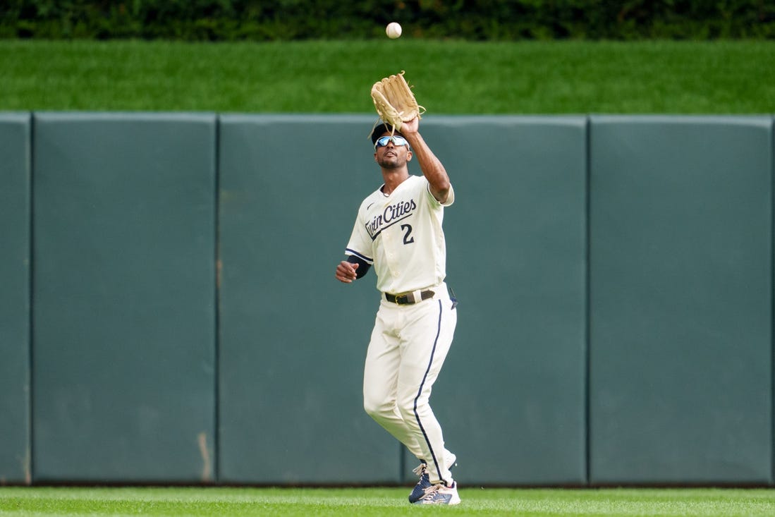 Sep 24, 2023; Minneapolis, Minnesota, USA; Minnesota Twins center fielder Michael A. Taylor (2) catches a ball to retire Los Angeles Angels catcher Logan O'Hoppe (14) in the second inning at Target Field. Mandatory Credit: Matt Blewett-USA TODAY Sports