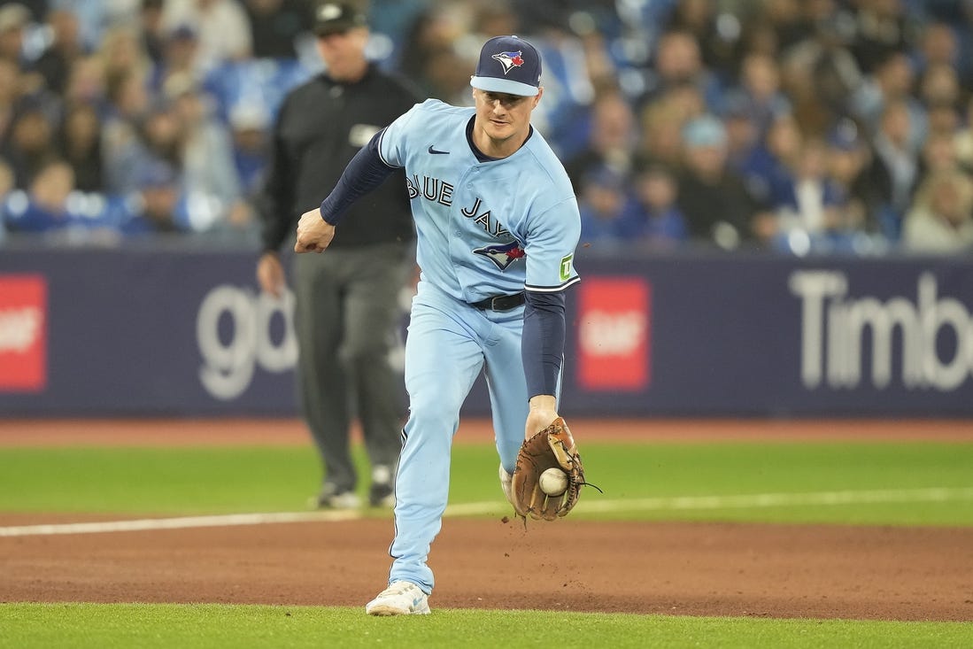 Sep 28, 2023; Toronto, Ontario, CAN; Toronto Blue Jays third baseman Matt Chapman (26) fields a ground ball hit by New York Yankees left fielder Oswaldo Cabrera (not pictured) during the ninth inning at Rogers Centre. Mandatory Credit: John E. Sokolowski-USA TODAY Sports