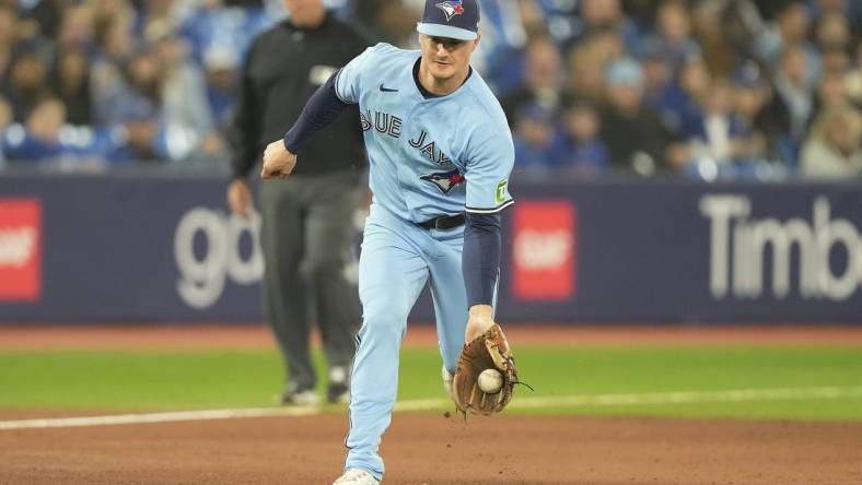 Sep 28, 2023; Toronto, Ontario, CAN; Toronto Blue Jays third baseman Matt Chapman (26) fields a ground ball hit by New York Yankees left fielder Oswaldo Cabrera (not pictured) during the ninth inning at Rogers Centre. Mandatory Credit: John E. Sokolowski-USA TODAY Sports