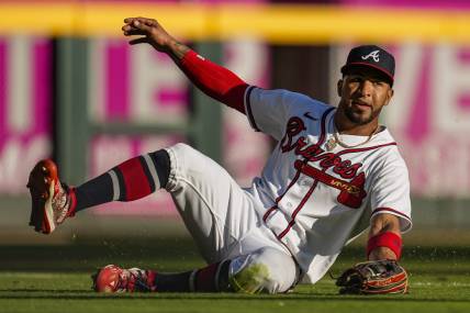 Oct 1, 2023; Cumberland, Georgia, USA; Atlanta Braves left fielder Eddie Rosario (8) makes a sliding catch on a ball hit by Washington Nationals shortstop CJ Abrams (5) (not shown) during the eighth inning at Truist Park. Mandatory Credit: Dale Zanine-USA TODAY Sports