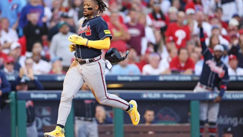 Oct 11, 2023; Philadelphia, Pennsylvania, USA; Atlanta Braves right fielder Ronald Acuna Jr. (13) scores a run on a hit by second baseman Ozzie Albies (not pictured) during the third inning against the Philadelphia Phillies in game three of the NLDS for the 2023 MLB playoffs at Citizens Bank Park. Mandatory Credit: Bill Streicher-USA TODAY Sports