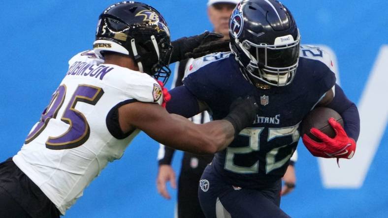 Oct 15, 2023; London, United Kingdom; Tennessee Titans running back Derrick Henry (22) carries the ball against Baltimore Ravens linebacker Tavius Robinson (95) in the second half during an NFL International Series game at Tottenham Hotspur Stadium. Mandatory Credit: Kirby Lee-USA TODAY Sports