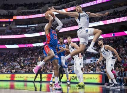 Oct 20, 2023; Dallas, Texas, USA; Dallas Mavericks guard Dante Exum (0) attempts to block a shot by Detroit Pistons guard Zavier Simpson (24) during the second half at the American Airlines Center. Mandatory Credit: Jerome Miron-USA TODAY Sports