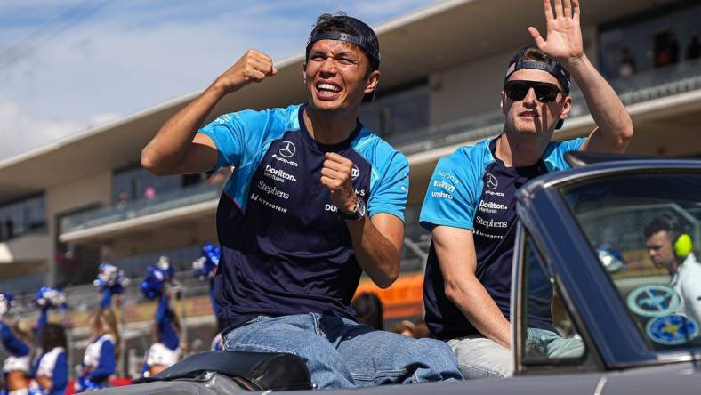 Williams Racing drivers Alex Albon, left, and Logan Sargeant, right wave to the crowd during the drivers parade ahead of the Formula 1 Lenovo United States Grand Prix at Circuit of Americas on Sunday Oct. 22, 2023.