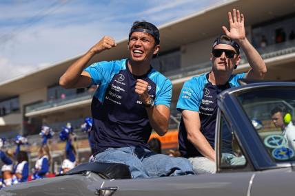 Williams Racing drivers Alex Albon, left, and Logan Sargeant, right wave to the crowd during the drivers parade ahead of the Formula 1 Lenovo United States Grand Prix at Circuit of Americas on Sunday Oct. 22, 2023.