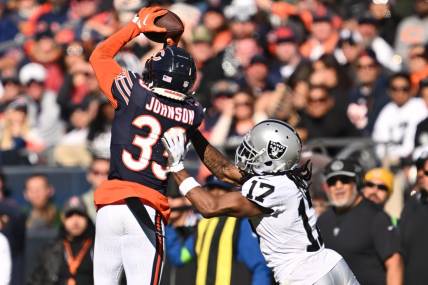 Oct 22, 2023; Chicago, Illinois, USA;  Chicago Bears defensive back Jaylon Johnson (33) steps in front of Las Vegas Raiders wide receiver Davante Adams (17) to intercept a pass before returning the ball for a touchdown in the fourth quarter at Soldier Field. Mandatory Credit: Jamie Sabau-USA TODAY Sports