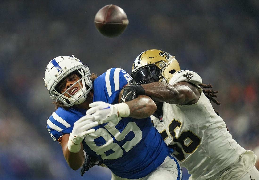 Indianapolis Colts tight end Drew Ogletree (85) is unable to receive thanks to defensive pressure from New Orleans Saints linebacker Demario Davis (56) on Sunday, Oct. 29, 2023, at Lucas Oil Stadium in Indianapolis.