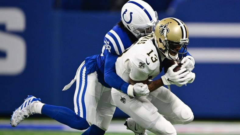 Oct 29, 2023; Indianapolis, Indiana, USA; Indianapolis Colts cornerback Tony Brown (38) tackles New Orleans Saints wide receiver Michael Thomas (13) during the first quarter at Lucas Oil Stadium. Mandatory Credit: Marc Lebryk-USA TODAY Sports