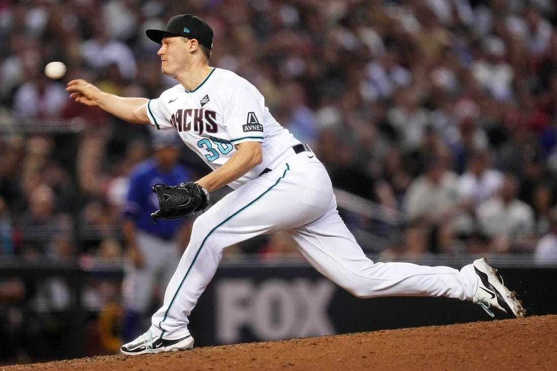 Arizona Diamondbacks relief pitcher Paul Sewald (38) pitches during the ninth inning during game five of the 2023 World Series at Chase Field.