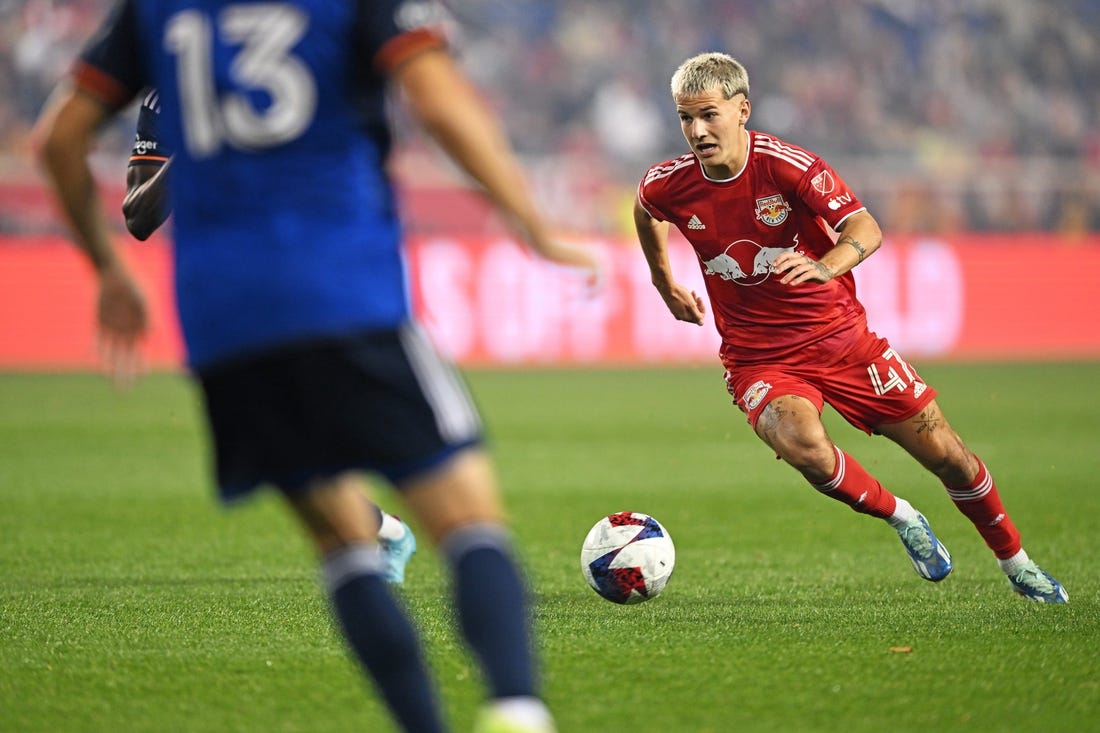 Nov 4, 2023; Harrison, NJ, USA; New York Red Bulls defender John Tolkin (47) controls the ball as FC Cincinnati defender Santiago Arias (13) defends during the first half of game two in a round one match of the 2023 MLS Cup Playoffs at Red Bull Arena. Mandatory Credit: Mark Smith-USA TODAY Sports