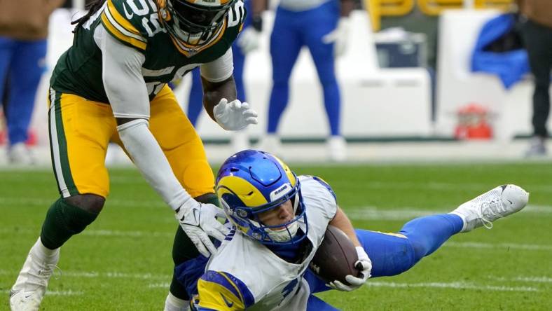 Los Angeles Rams quarterback Brett Rypien (11) slides for a first down before being downed by Green Bay Packers linebacker De'Vondre Campbell (59) during the second quarter of their game at Lambeau Field Sunday, November 5, 2023 in Green Bay, Wisconsin.