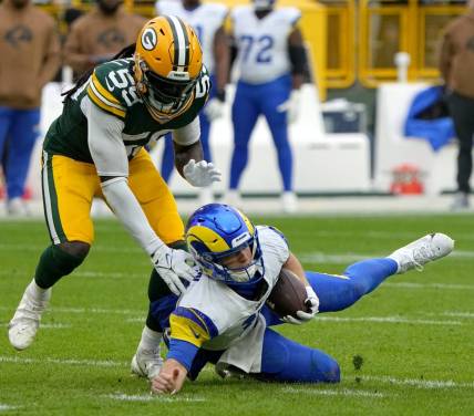 Los Angeles Rams quarterback Brett Rypien (11) slides for a first down before being downed by Green Bay Packers linebacker De'Vondre Campbell (59) during the second quarter of their game at Lambeau Field Sunday, November 5, 2023 in Green Bay, Wisconsin.