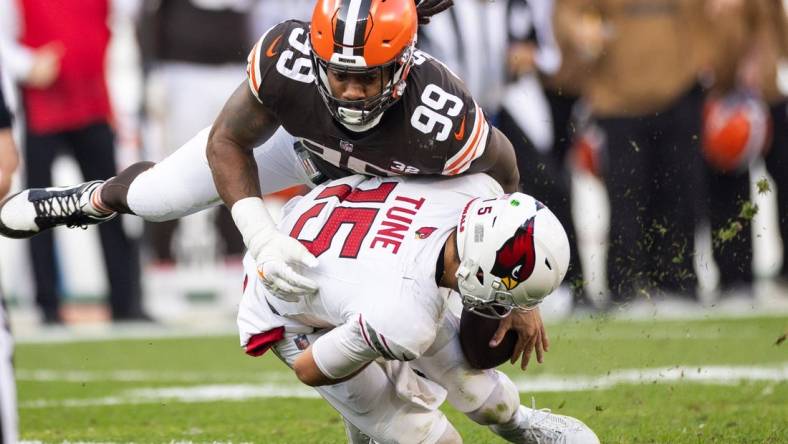 Nov 5, 2023; Cleveland, Ohio, USA; Cleveland Browns defensive end Za'Darius Smith (99) sacks Arizona Cardinals quarterback Clayton Tune (15) during the fourth quarter at Cleveland Browns Stadium. Mandatory Credit: Scott Galvin-USA TODAY Sports