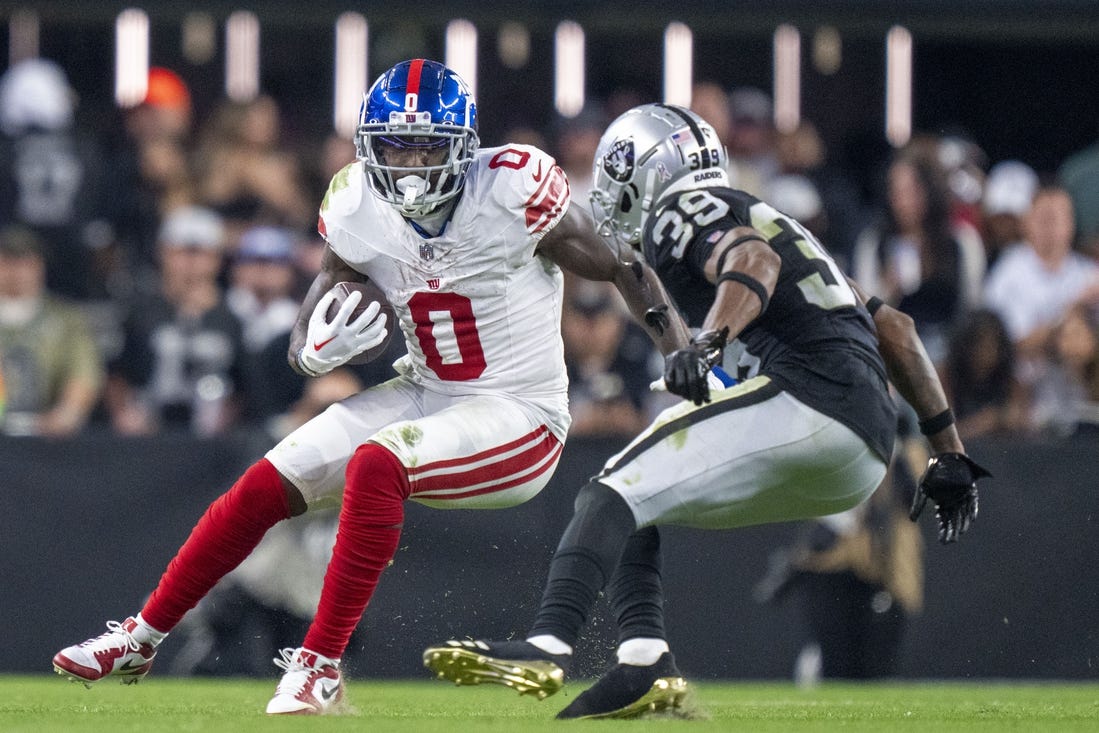 November 5, 2023; Paradise, Nevada, USA; New York Giants wide receiver Parris Campbell (0) runs the football against Las Vegas Raiders cornerback Nate Hobbs (39) during the fourth quarter at Allegiant Stadium. Mandatory Credit: Kyle Terada-USA TODAY Sports