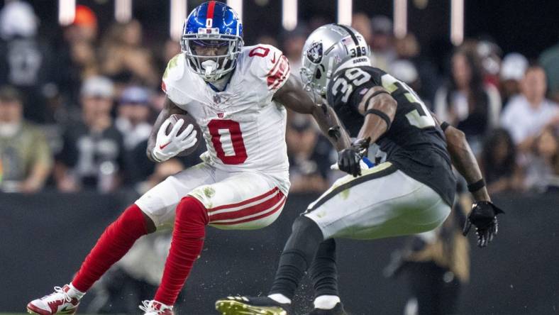 November 5, 2023; Paradise, Nevada, USA; New York Giants wide receiver Parris Campbell (0) runs the football against Las Vegas Raiders cornerback Nate Hobbs (39) during the fourth quarter at Allegiant Stadium. Mandatory Credit: Kyle Terada-USA TODAY Sports