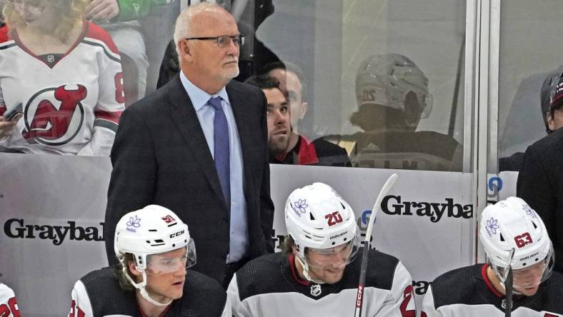 Nov 5, 2023; Chicago, Illinois, USA; New Jersey Devils head coach Lindy Ruff stands behind the bench during the first period at United Center. Mandatory Credit: David Banks-USA TODAY Sports