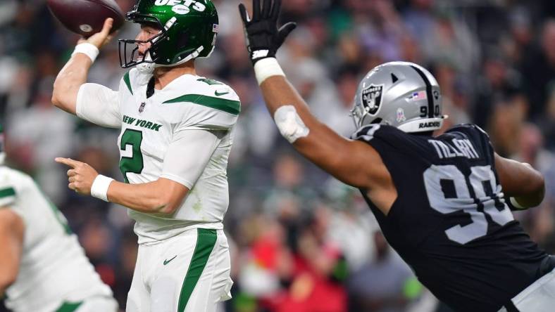 Nov 12, 2023; Paradise, Nevada, USA; New York Jets quarterback Zach Wilson (2) throws under pressure from Las Vegas Raiders defensive tackle Jerry Tillery (90) during the second half at Allegiant Stadium. Mandatory Credit: Gary A. Vasquez-USA TODAY Sports