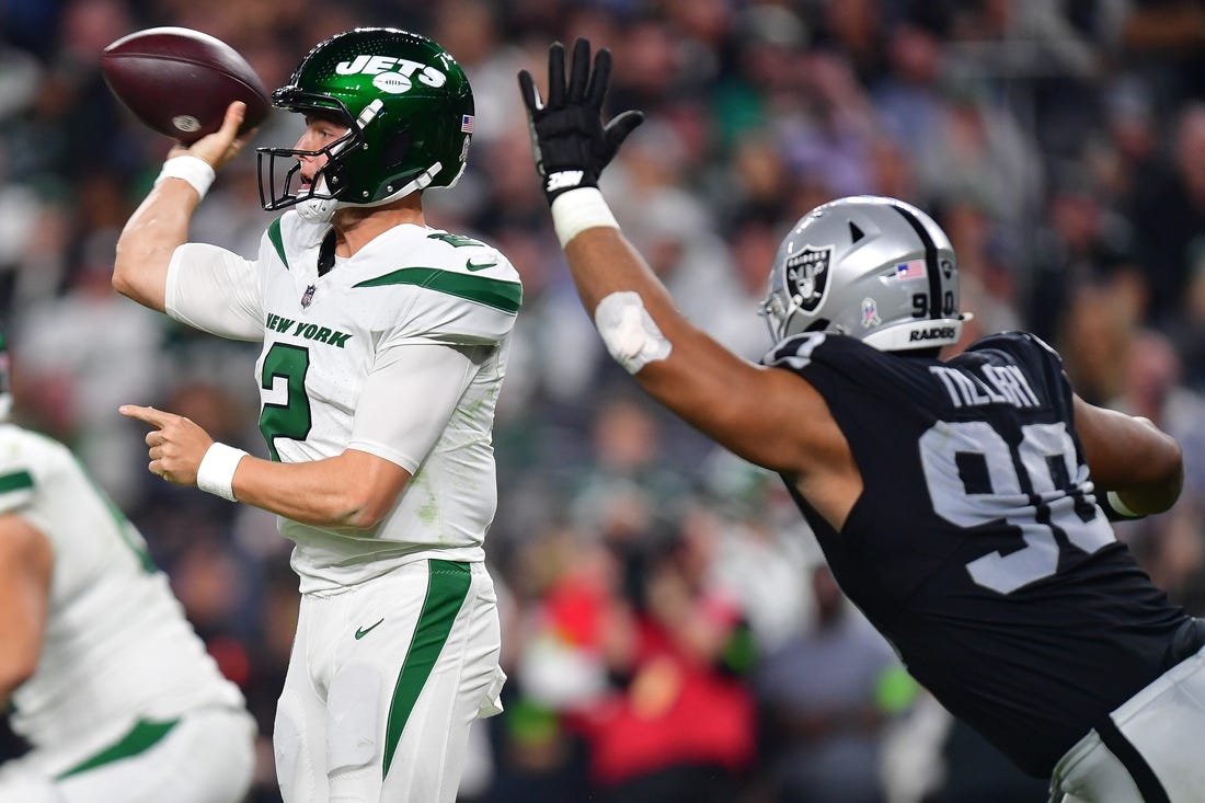 Nov 12, 2023; Paradise, Nevada, USA; New York Jets quarterback Zach Wilson (2) throws under pressure from Las Vegas Raiders defensive tackle Jerry Tillery (90) during the second half at Allegiant Stadium. Mandatory Credit: Gary A. Vasquez-USA TODAY Sports