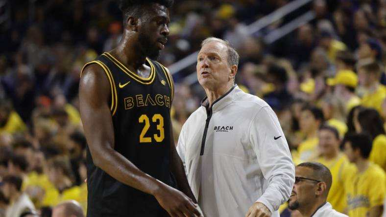 Nov 17, 2023; Ann Arbor, Michigan, USA;  Long Beach State 49ers head coach Dan Monson talks to 49ers forward Lassina Traore (23) in the first half at Crisler Center. Mandatory Credit: Rick Osentoski-USA TODAY Sports