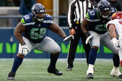 Nov 12, 2023; Seattle, Washington, USA; Seattle Seahawks guard Damien Lewis (68) reacts to a snap against the Washington Commanders during the second quarter at Lumen Field. Mandatory Credit: Joe Nicholson-USA TODAY Sports