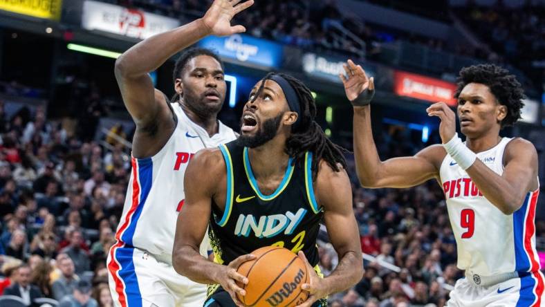 Nov 24, 2023; Indianapolis, Indiana, USA; Indiana Pacers forward Isaiah Jackson (22) shoots the ball while Detroit Pistons center Isaiah Stewart (28) and forward Ausar Thompson (9) defend in the second half at Gainbridge Fieldhouse. Mandatory Credit: Trevor Ruszkowski-USA TODAY Sports