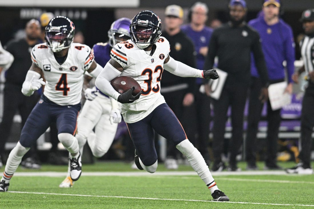 Nov 27, 2023; Minneapolis, Minnesota, USA; Chicago Bears cornerback Jaylon Johnson (33) returns an interception as safety Eddie Jackson (4) looks on against the Minnesota Vikings during the second quarter at U.S. Bank Stadium. Mandatory Credit: Jeffrey Becker-USA TODAY Sports